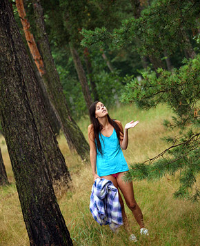 A gorgeous teenage brunette stroking cooch in the woods