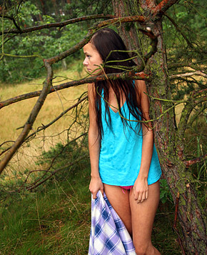 A gorgeous teenage brunette stroking cooch in the woods
