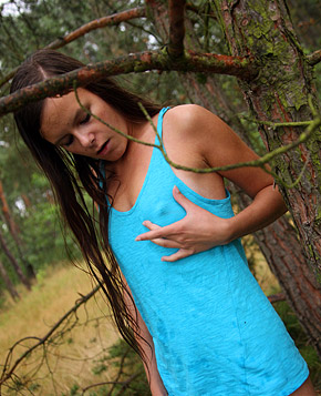 A gorgeous teenage brunette stroking cooch in the woods