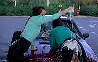 Pretty cute hotties becoming very dirty near a large car