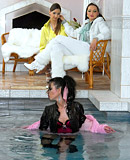 Horny beauties swimming in a pool with their clothes on