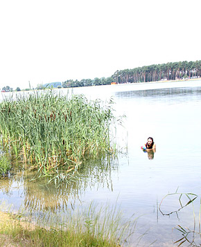 Very cute swimming teenager blowing pecker on the beach