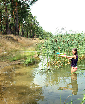 Very cute swimming teenager blowing pecker on the beach