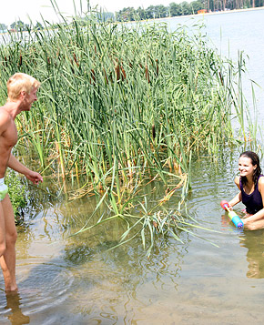 Very cute swimming teenager blowing pecker on the beach