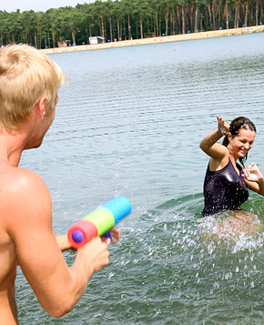 Very cute swimming teenager blowing pecker on the beach