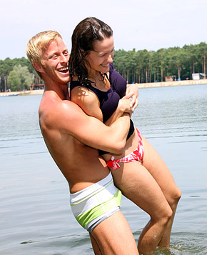 Very cute swimming teenager blowing pecker on the beach