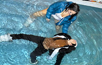 Sexy clothed lesbian sweeties swimming in a public pool