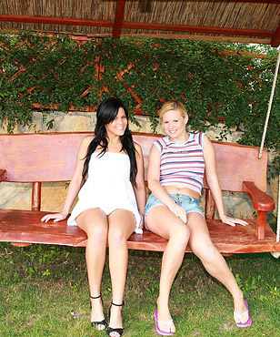 Two lesbian beauties massaging their wet cunts outdoors