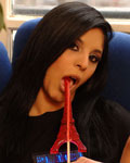 Angelika plays with an Eiffel Tower lollipop