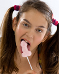 Cute pigtailed teen stripping in studio with lollipop...
