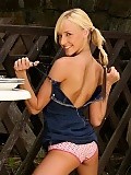  Flirty blonde slowly strips and dildos slick twat in garden