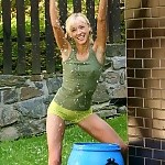  Adorable blonde pours water on lithe body and rubs bald quim