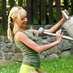  Adorable blonde pours water on lithe body and rubs bald quim