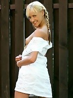 Blonde cutie flirtatiously undresses and poses in garden