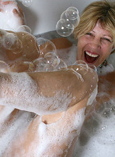 Nude mature housewife Rosetta gets soaking wet in the bath tub