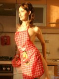 Sexy girl adel has some fun in the kitchen wearing only an apron and a thong