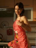 Sexy girl adel has some fun in the kitchen wearing only an apron and a thong