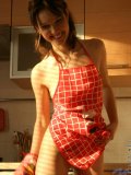 Sexy girl adel has some fun in the kitchen wearing only an apron and a thong