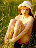 Charming honey girl with tasty body goes totally naked on a tree trunk