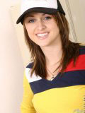 Sweet teen in a truckers cap and a tight yellow top looks hot