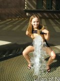 Gorgeous teen plays in the water on a hot day