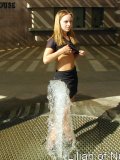 Gorgeous teen plays in the water on a hot day